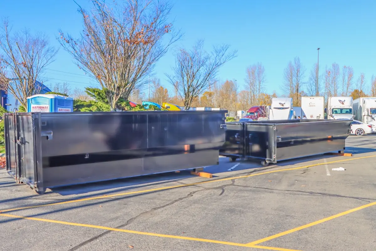 Professional dumpster rental service with roll-off container on residential driveway in Spanish Springs